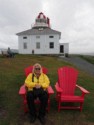 Linda sits in front of the old lighthouse